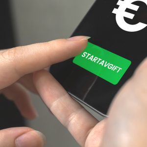 a person holding a green button